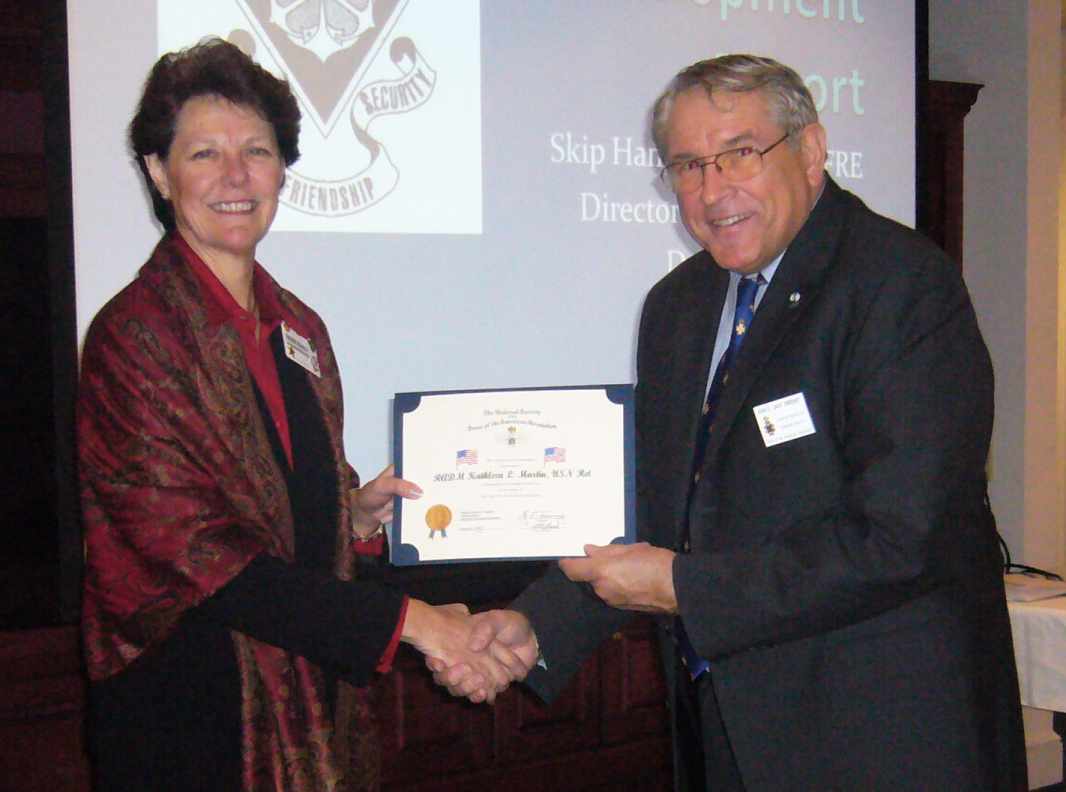 Rear Admiral Kathleen Martin receives an SAR Flag certificate for Vinson Hall